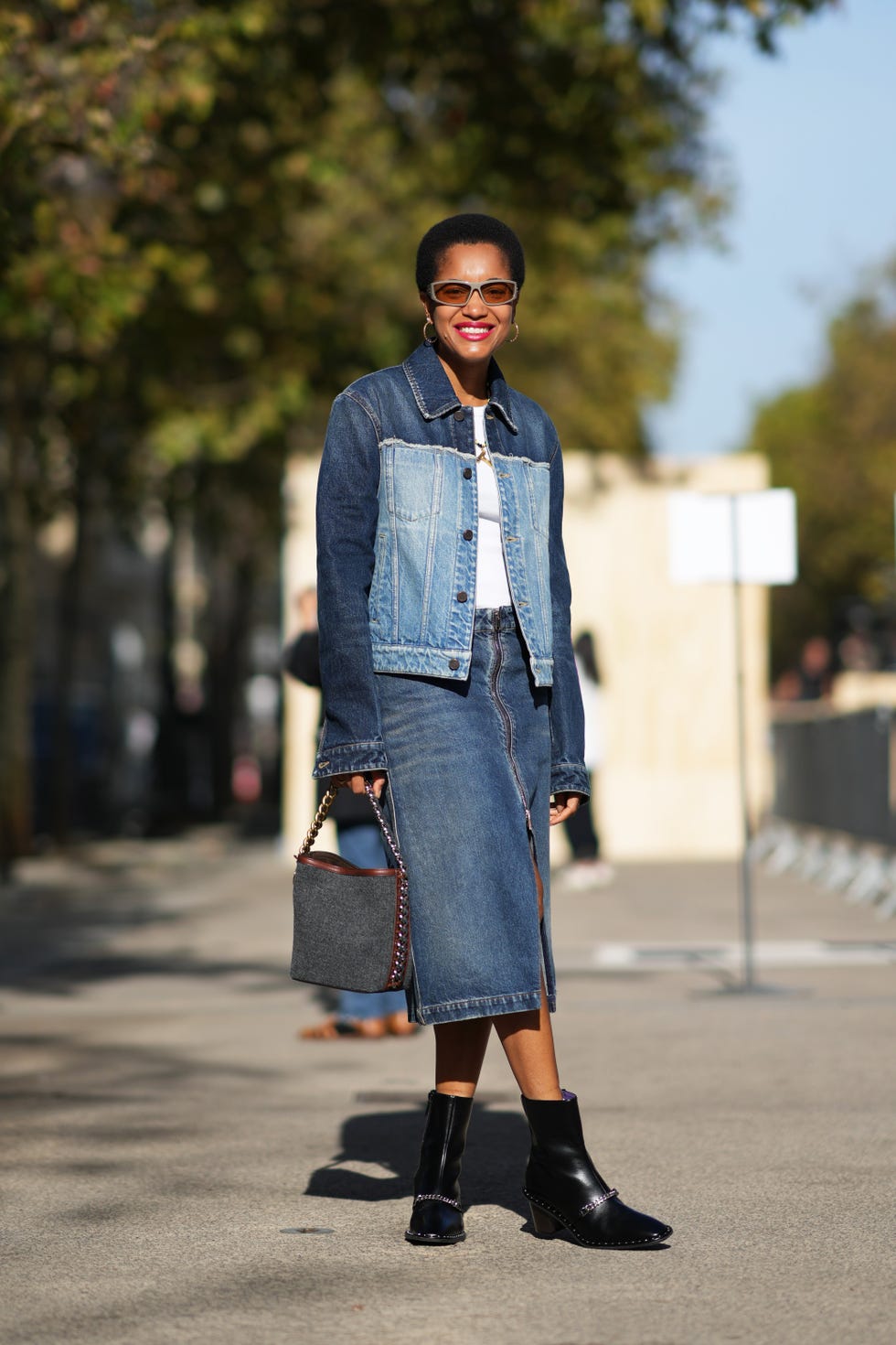tamu mcpherson wears sunglasses, a bi color dark blue and pale blue denim jacket, a white t shirt, a blue slit denim skirt, a bag, black leather ankle boots, outside stella mccartney, during the womenswear springsummer 2024 as part of paris fashion week on october 02, 2023 in paris, france photo by edward berthelotgetty images